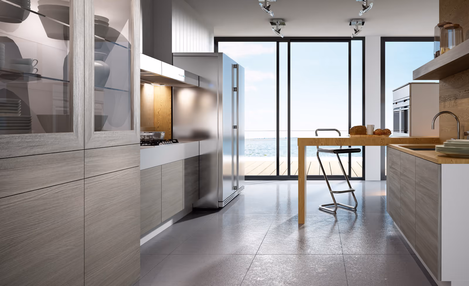 Cocina ARYCO en tonos grises con barra de madera junto a un ventanal con vistas al mar